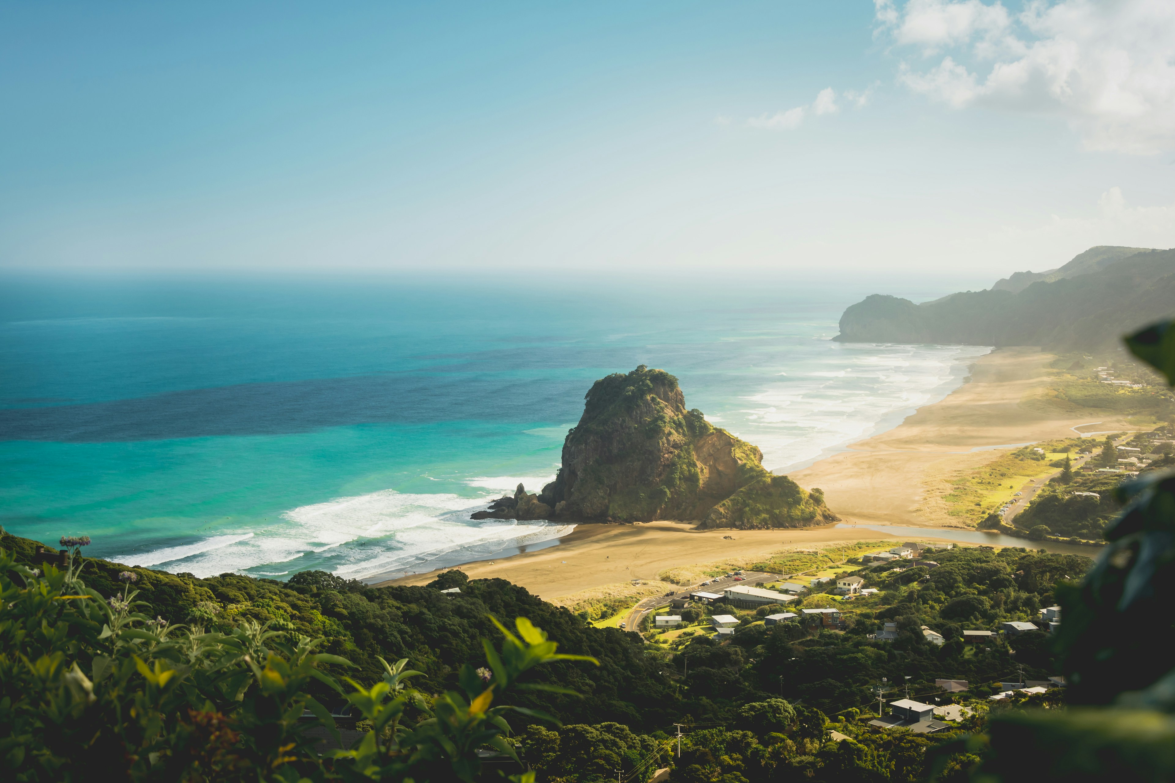 Lion Rock stands sentinel over Piha’s black-sand beach – a favorite spot for surfers and photographers